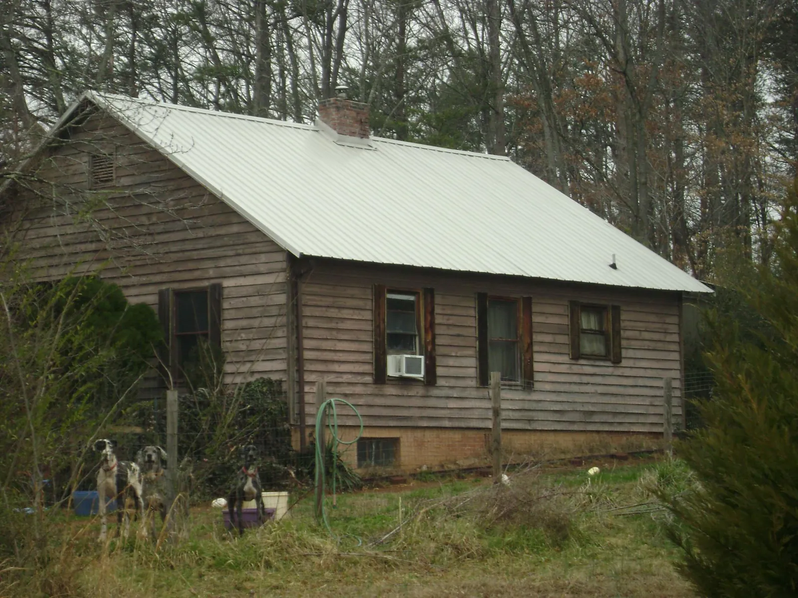 White metal roof on an old wood sided farmhouse, from a Metal Roof Installation job in Toulon